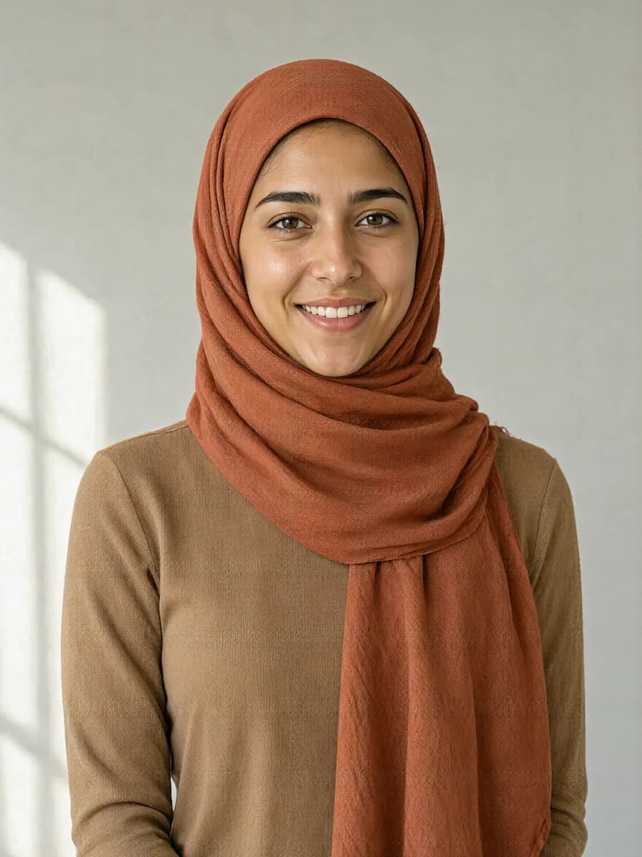 A woman with olive skin and a warm undertone in a terracotta hijab