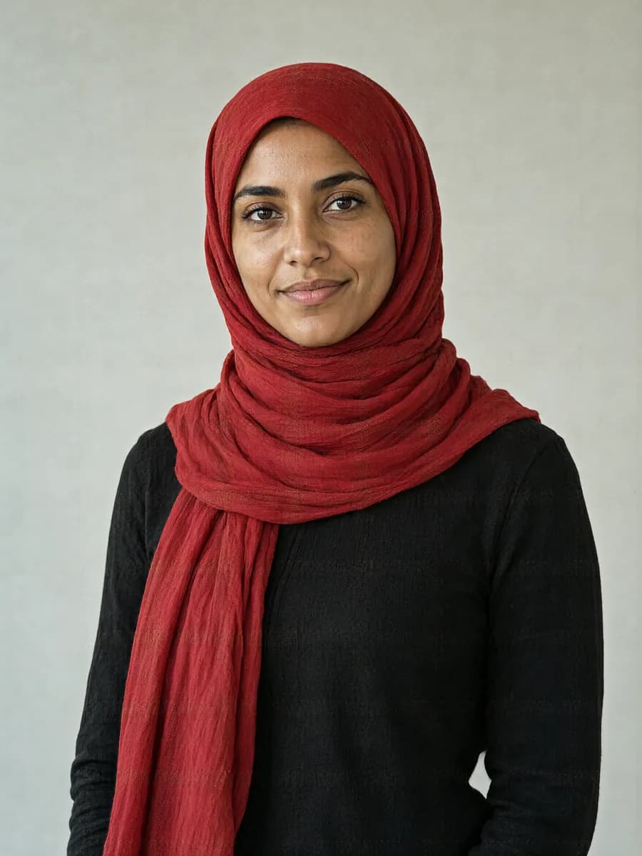 A woman with brown skin and a cool undertone in a red hijab